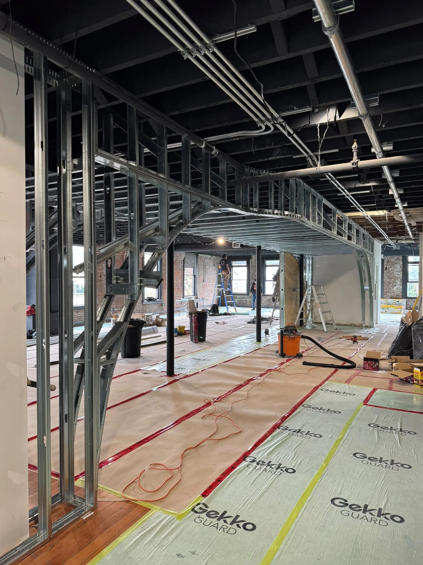 Steel-stud framed archway with floor protection on an Enduro commercial general contractor fit-out in Metro Vancouver