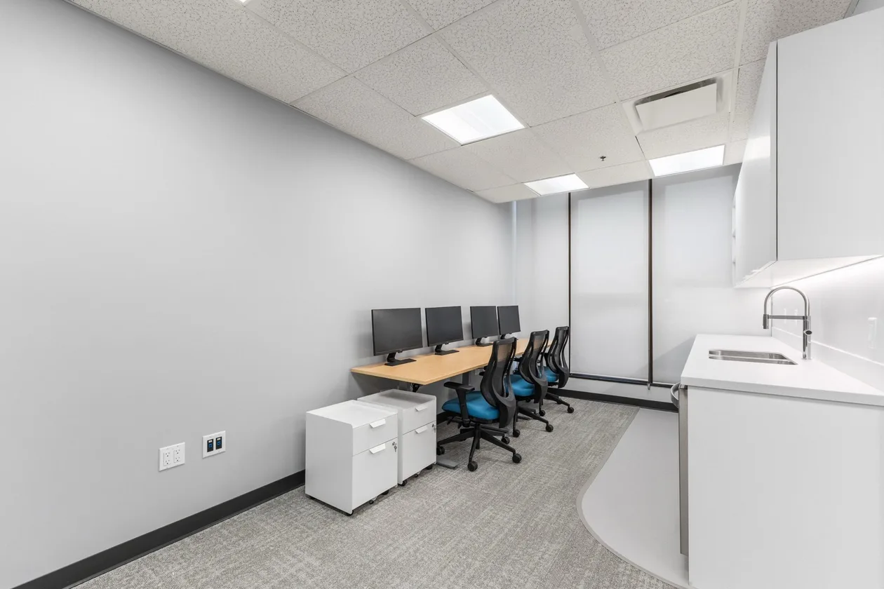Open workstation bench with blue task chairs