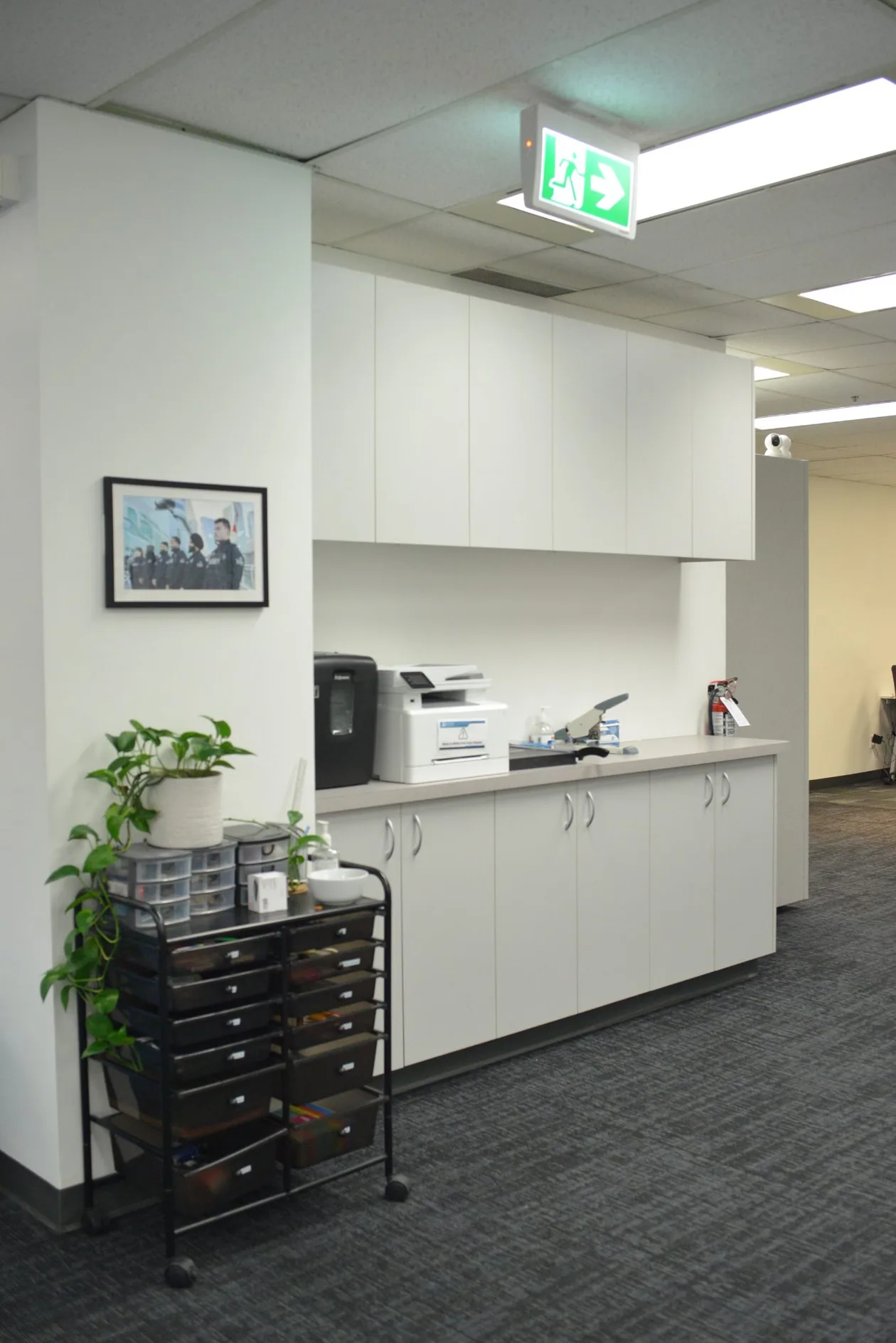 Print and copy station with white millwork, upper cabinets and open shelving
