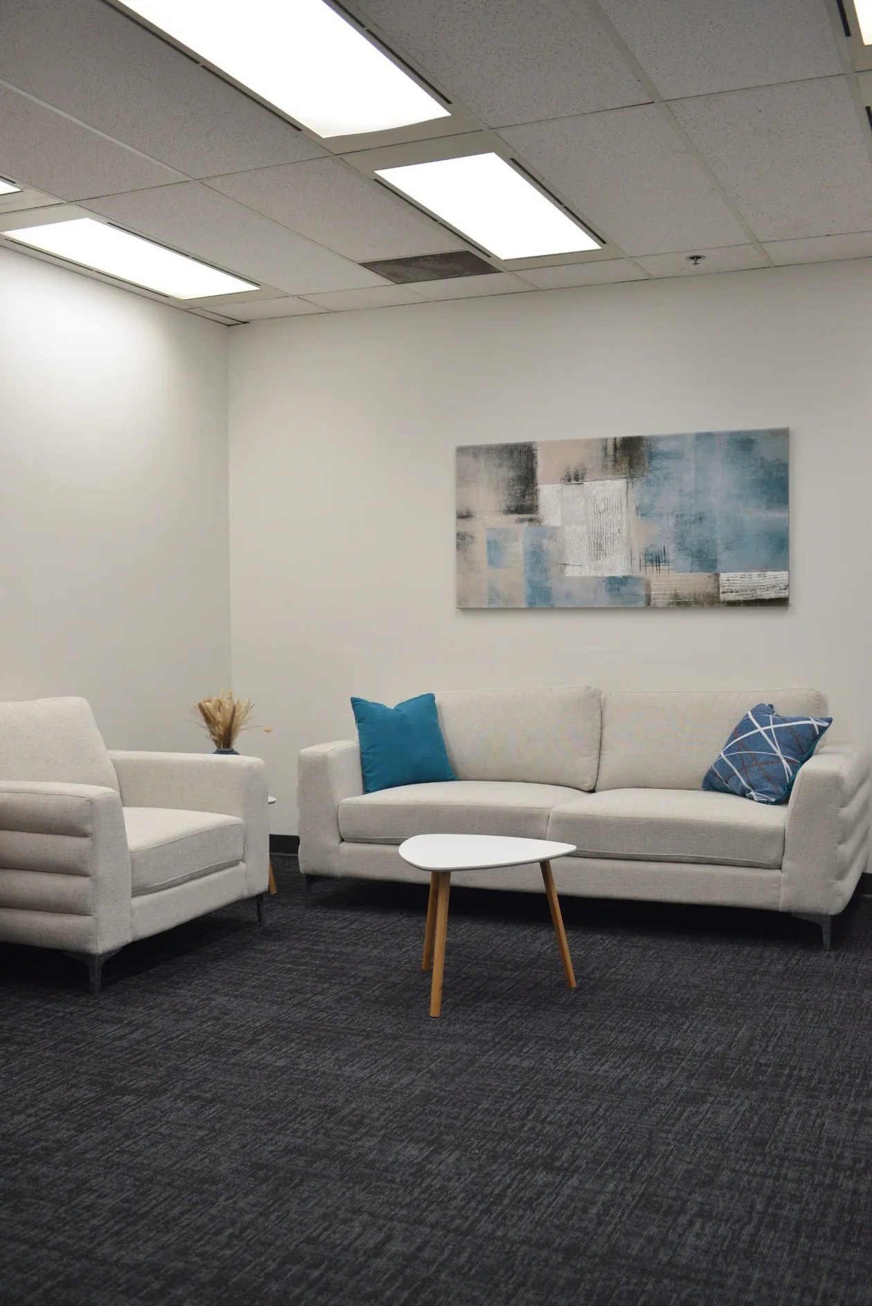Soft seating lounge with a fabric sofa, armchairs and a low round coffee table