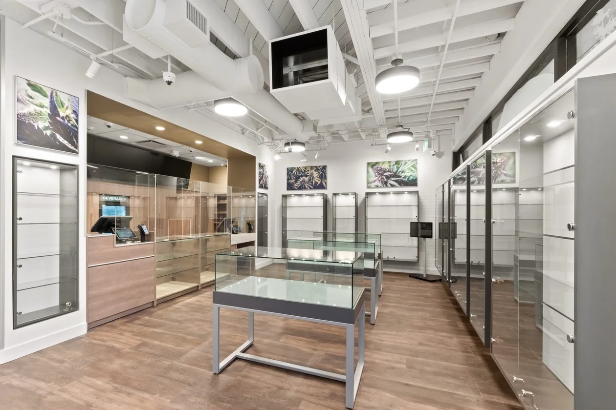 Norgate Cannabis North Vancouver retail fit-out — sales floor with glass display cases, timber wall units and exposed ceiling services