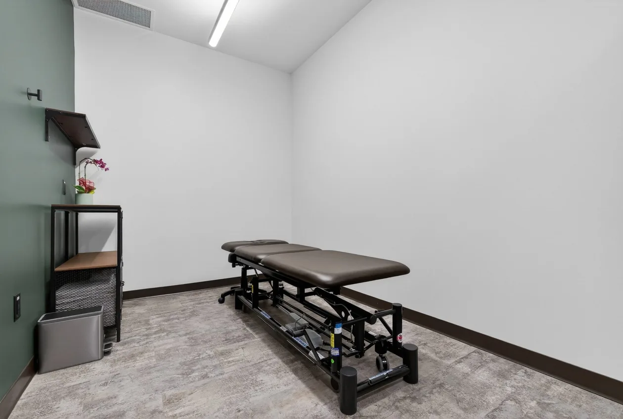 Second treatment room with therapy table and storage