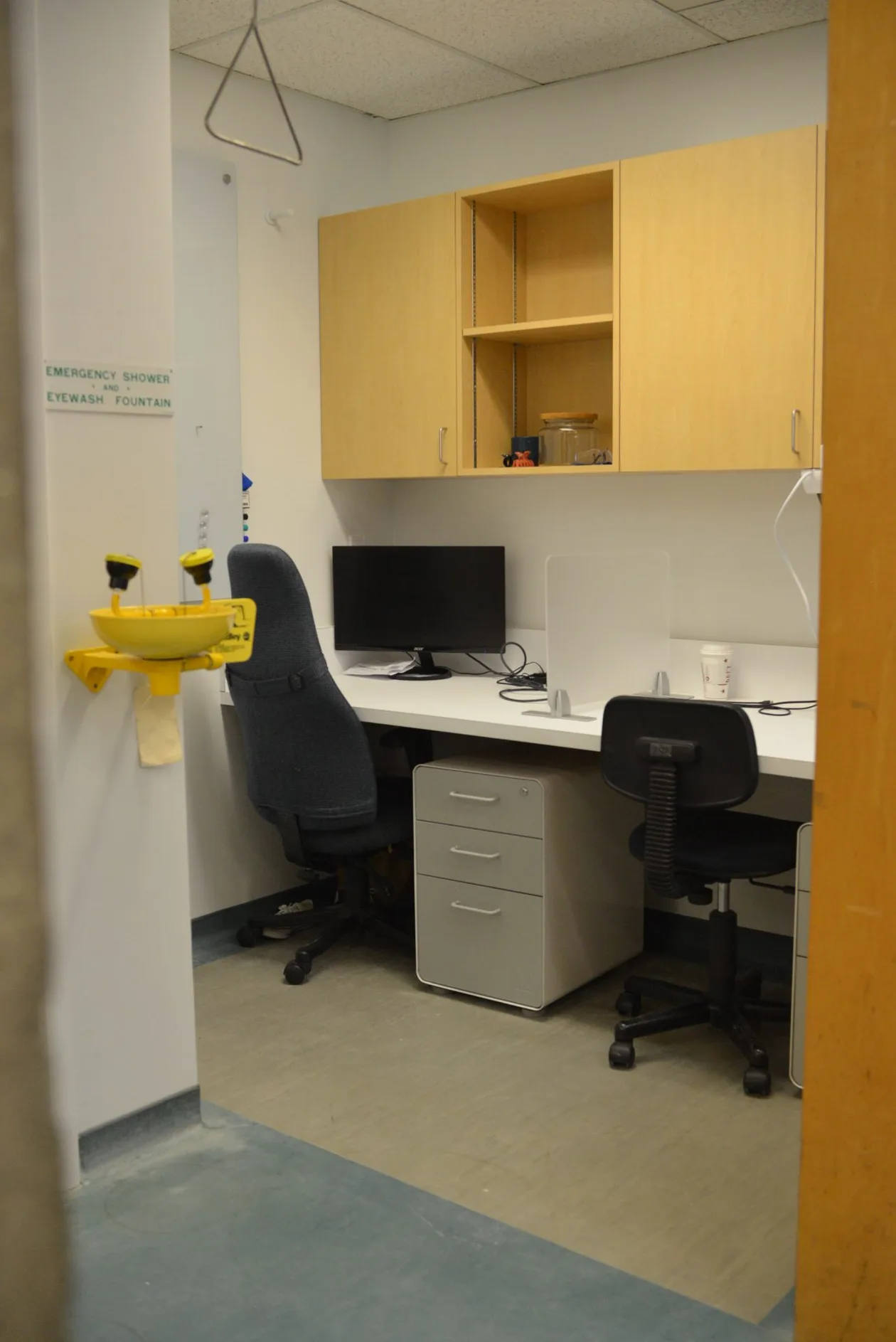 Write-up office with timber upper cabinets, desk run and task chairs