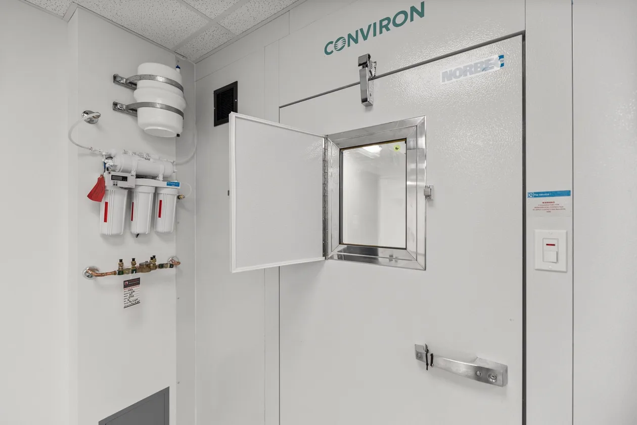Environmental growth chamber exterior with viewing port and service valves