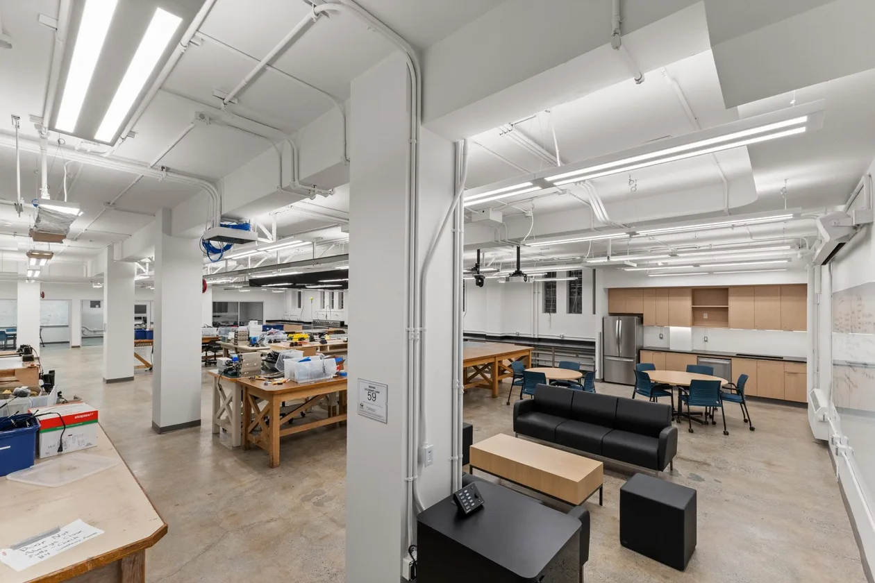 UBC Henning capstone lab renovation — timber workbenches under exposed services on polished concrete
