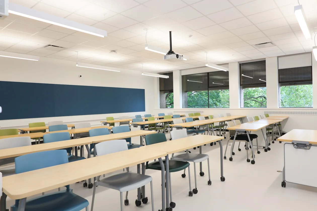 Renovated classroom with blue accent wall and new glazing, UBC MacMillan Building, Vancouver BC.